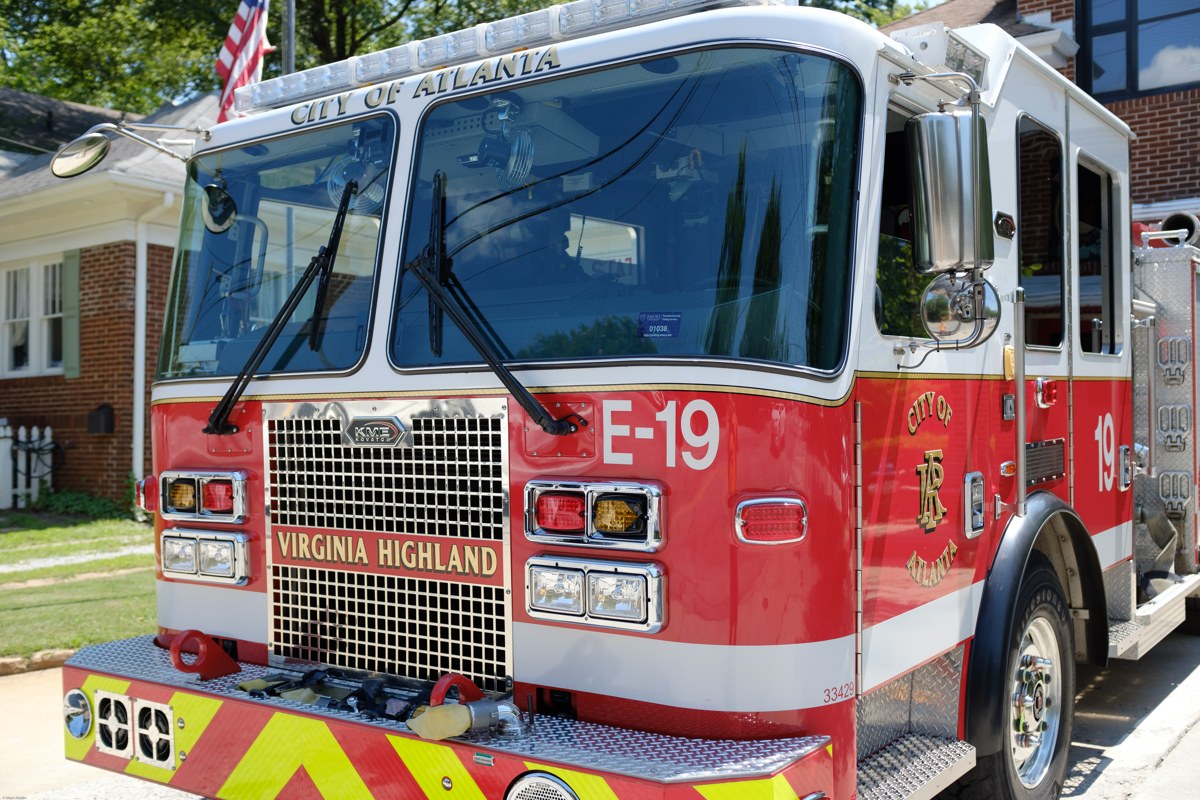 Red KME fire engine parked in front of its fire station