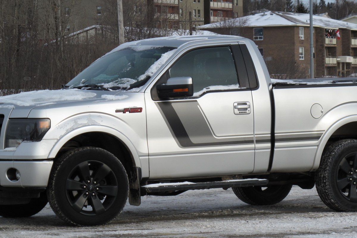 2014 Ford F-150 FX4 Tremor in silver, snow on the hood, still on the road in 2022
